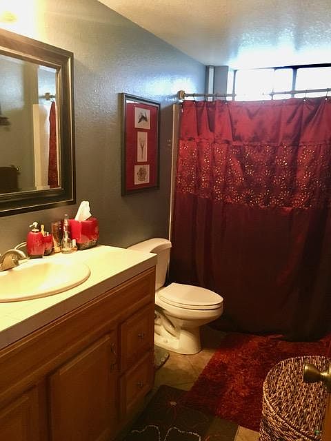 Full bath includes tiled bathtub/shower and full-sized vanity with storage below.