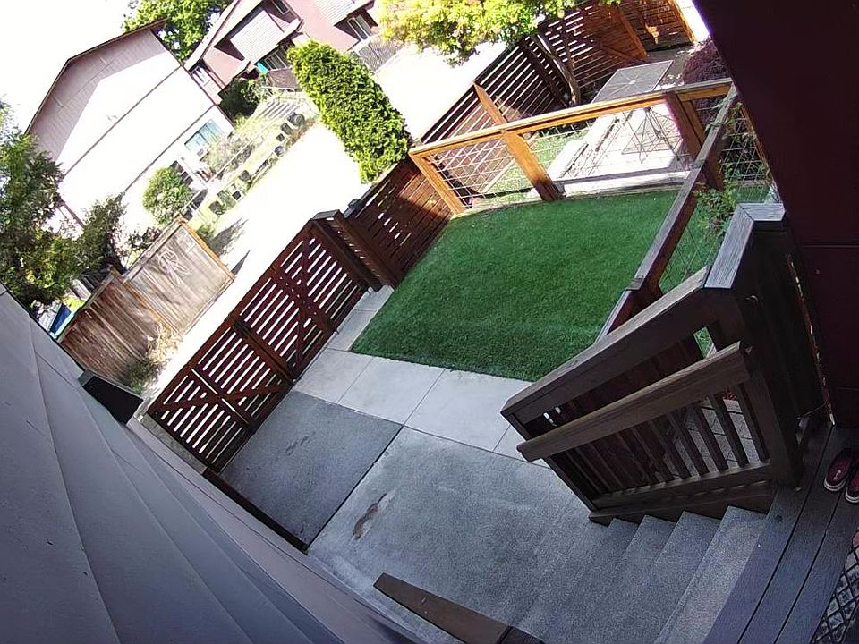 View of the yard - entertainment space - from Ring camera. A compact car can be parked (a second parking space) on the concrete