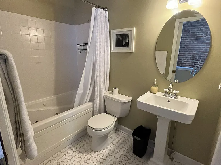 Third floor full bathroom with jacuzzi tub and storage closet