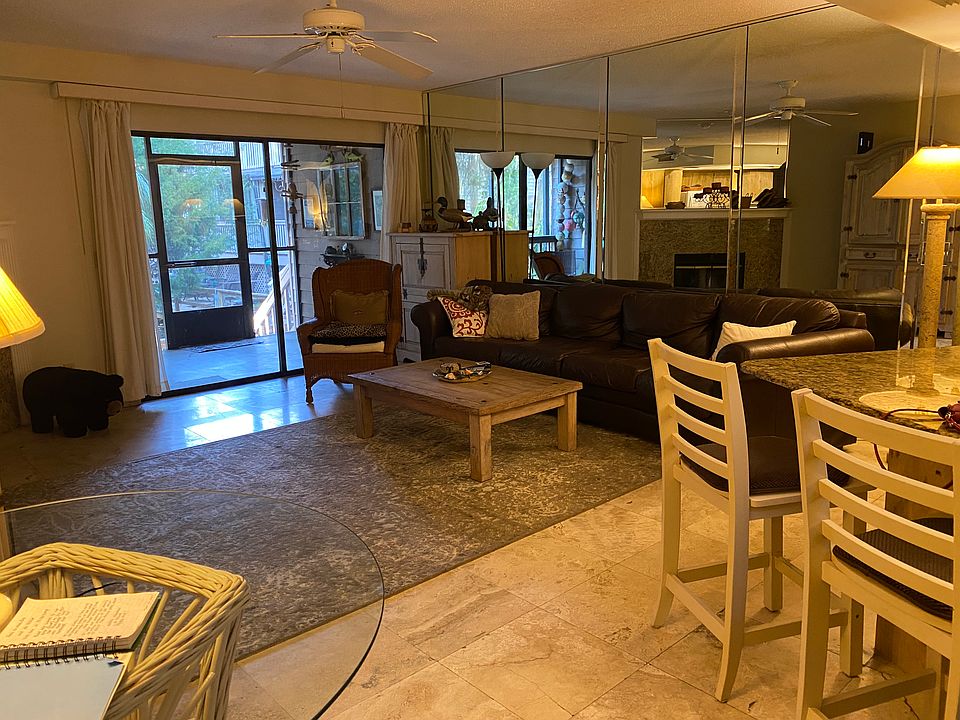 Living room, Porch. Leather Sofa, Fireplace, 2-seat Bar + Table. Travertine Floors