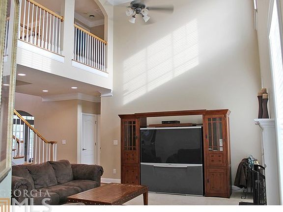 Two story great room with fireplace. Plenty of space for large pieces of furniture