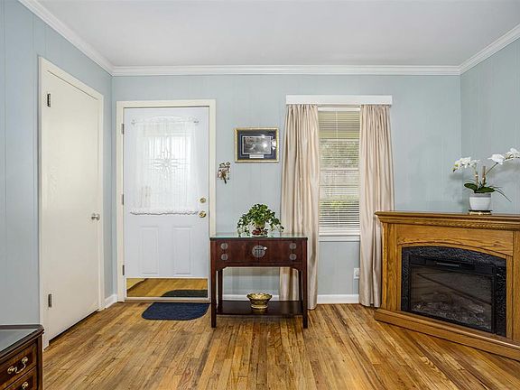 Living room with wood floors and closet.