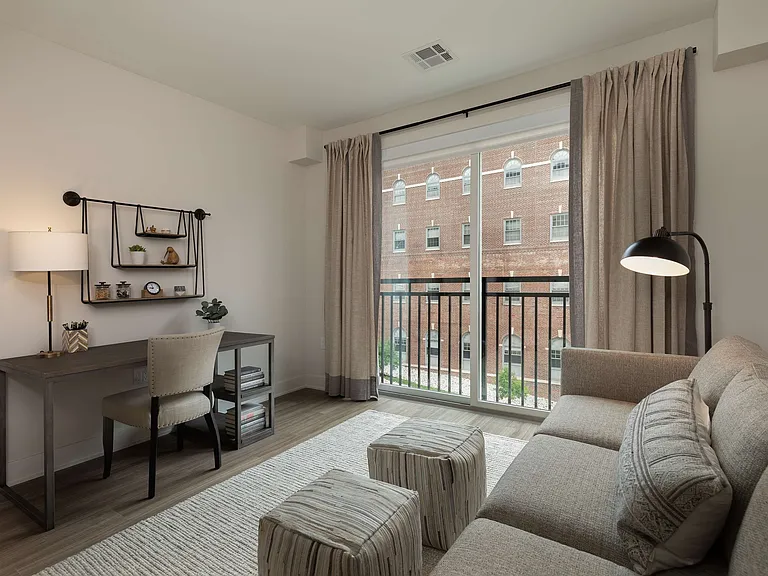 Embrace urban elegance in this beautifully designed apartment space featuring work and relaxation areas.