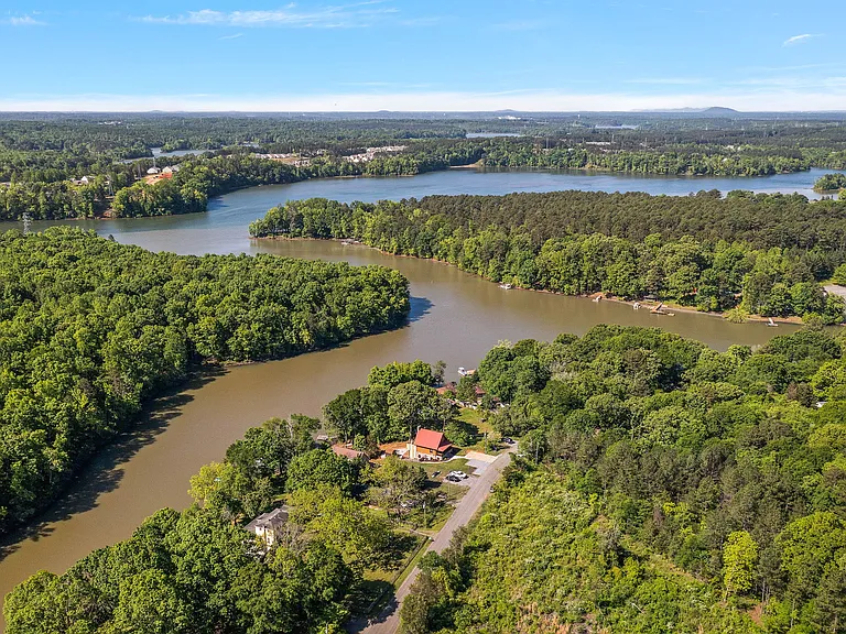 Overhead view - the lake house has the red metal roof. Located on a quiet dead-end private street.