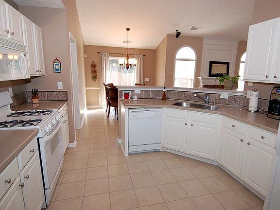 Updated kitchen w/Corian counters, tile bksplsh, new tile, & large pantry!