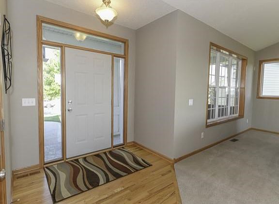 Spacious entryway with hardwood floors and large closet.