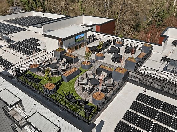 Sumner apartments with a rooftop terrace offering outdoor seating, social spaces, and scenic views.