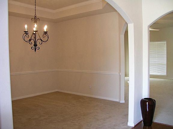 The dining room just off the entry with the living room and kitchen adjacent.