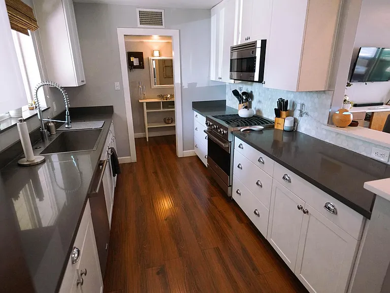 View of gallery kitchen, into front entry