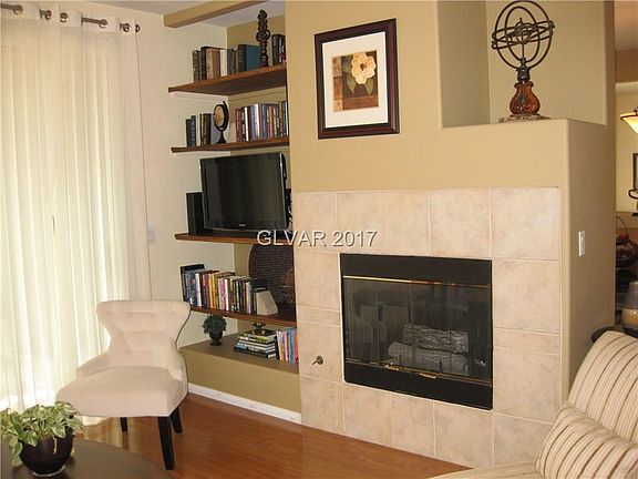 Gas fireplace, built in bookshelves & a slider to one of two covered patios.