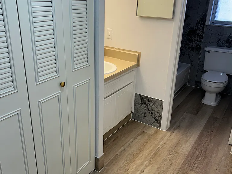 Spacious bath with large linen closet.
