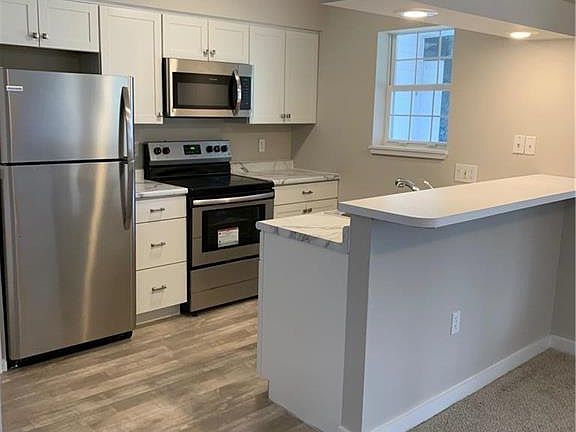 New white cabinets and stainless steel appliances