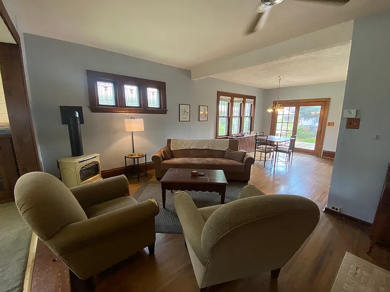 Open living and dining rooms feature stained glass and views to the backyard.