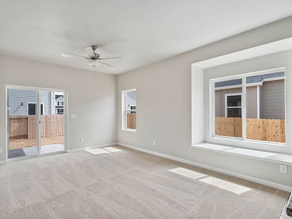 The family room is spacious with reading nooks and a ceiling fan.