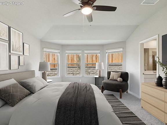 Virtually staged primary suite in the Hughes floorplan at a Meritage Homes community.