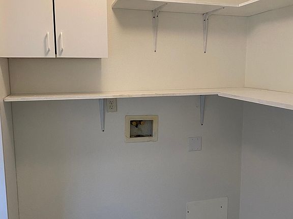 Laundry room with shelving and pantry