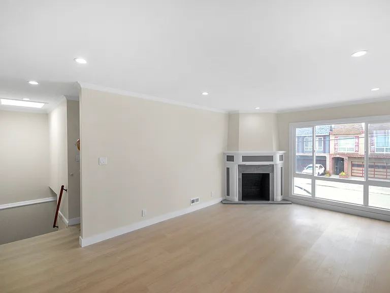 Stairway with skylight entering to upstairs living space