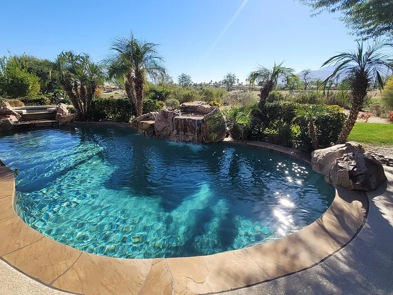 A large pool, waterfall, and spa, can be heated. View of the golf course and mountains.