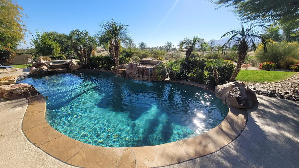 A large pool, waterfall, and spa, can be heated. View of the golf course and mountains. - 81265 Kingston Heath