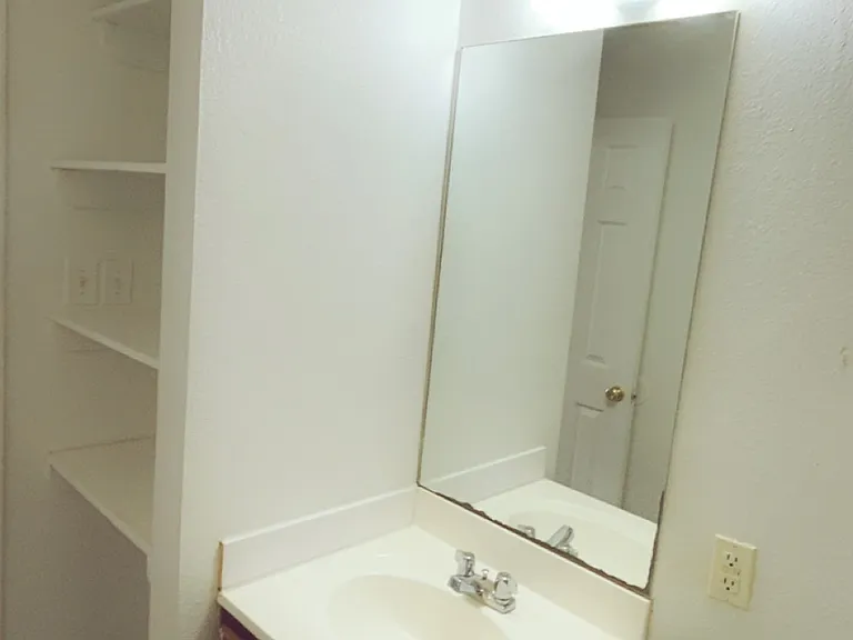 1 bedroom unit: bathroom with built-in shelving