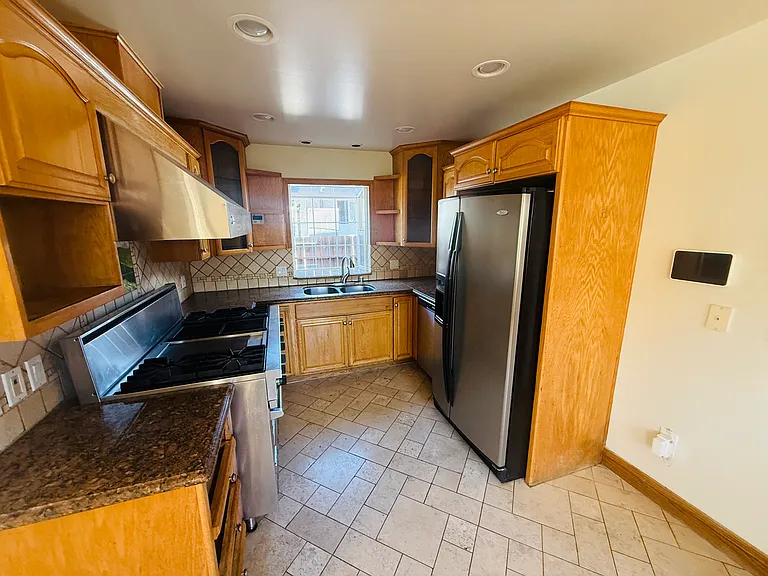 View of Kitchen - Viking stove, stainless steel fridge, dishwasher