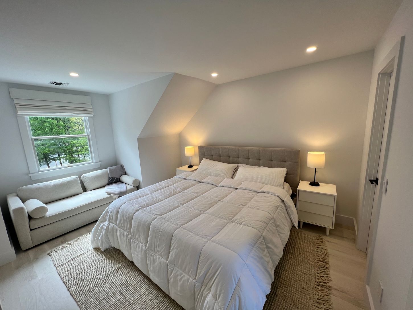  2nd floor junior primary suite: king bed, couch, walk- in closet, full bath, crib , and a desk