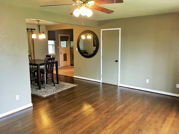Living room looking towards dining and kitchen. Garage access