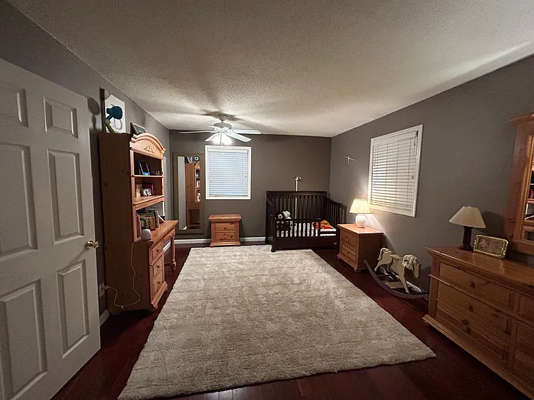 An additional view of the large bedroom located in the front of the house.