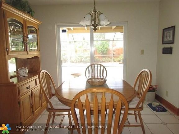 DINING ROOM- SLIDERS LEAD TO THE COVERED PATIO AND POOL