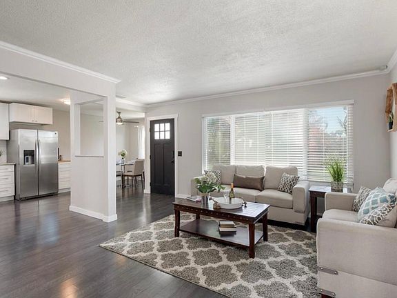 Living room area and the kitchen and the dining room in the back