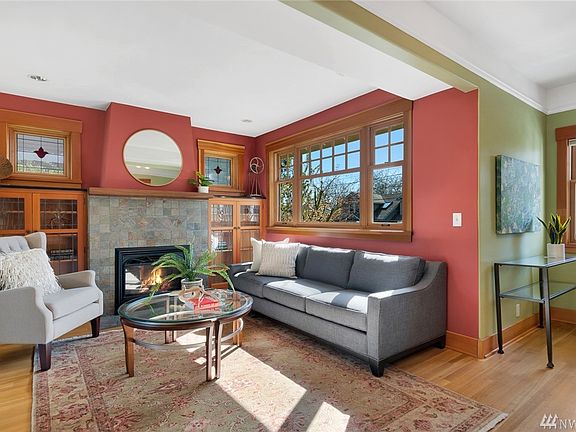The living room is the heart of the home!  Oak floors &  beautiful woodwork, charming windows & a cozy fireplace add up to a traditional gathering space. 