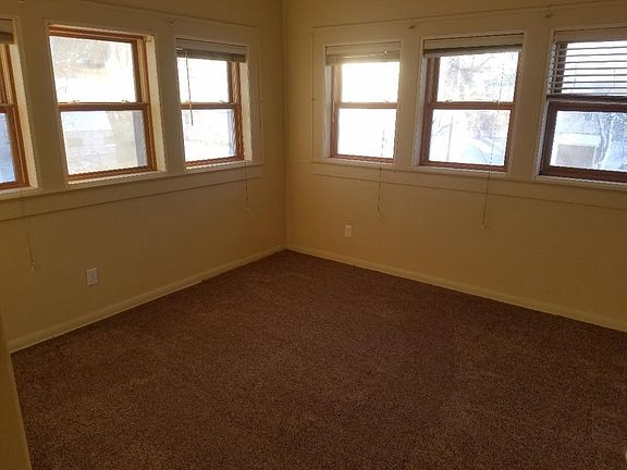 Spacious Living Room with new carpet and paint. 6 large win