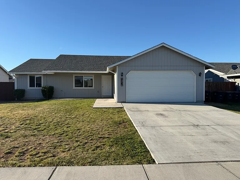 1,336 sq. ft single family home with three beds, two baths, large yards, and attached two-car garage.