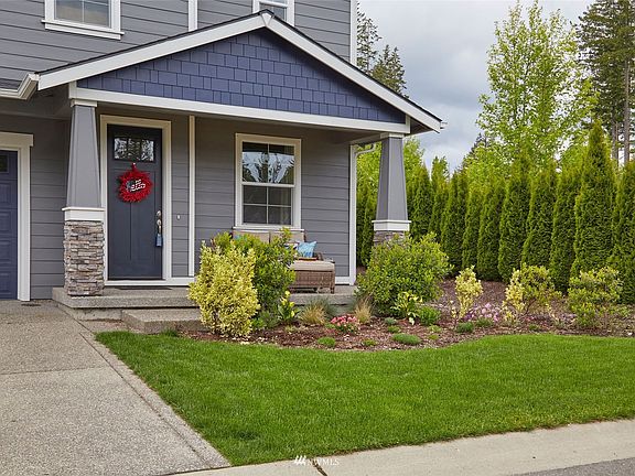 Covered back patio area with hot tub (only about 2 years old and is included in the listing). fully fenced backyard. 