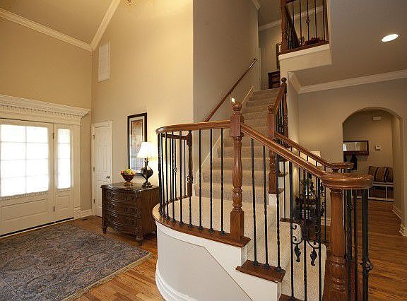 Entry features high ceiling, moldings, and hardwoods