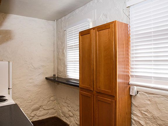 Back bar and standing pantry in kitchen add functionality and utility.