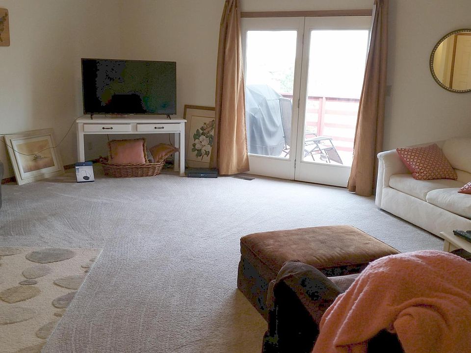 Living room on main floor has ceiling fan, cathedral ceiling and deck