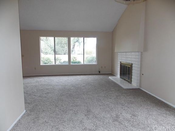 Bright living room with vaulted ceilings and fireplace