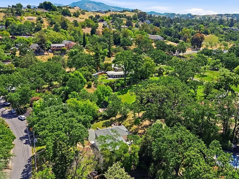 Surrounded by mature trees and rolling hills