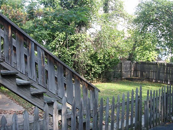 View of Backyard with Stairwell (to first and second floor sunrooms).