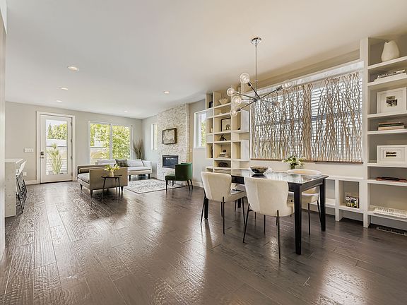 Spacious and bright, the dining area has custom-designed shelves surrounding the window to add architectural interest and functionality.