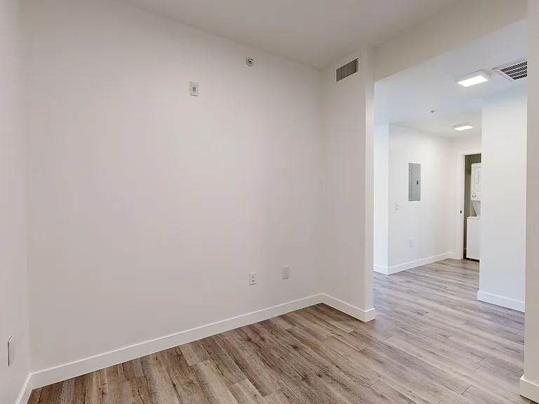 Apartment study with wood-style flooring.