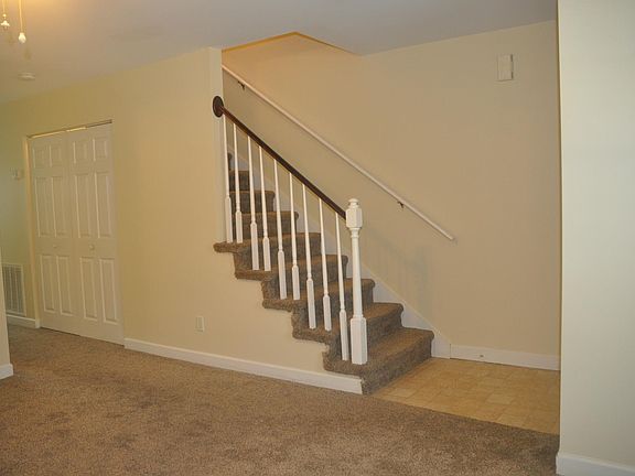 Living Room showing closet containing Laundry hook ups and s