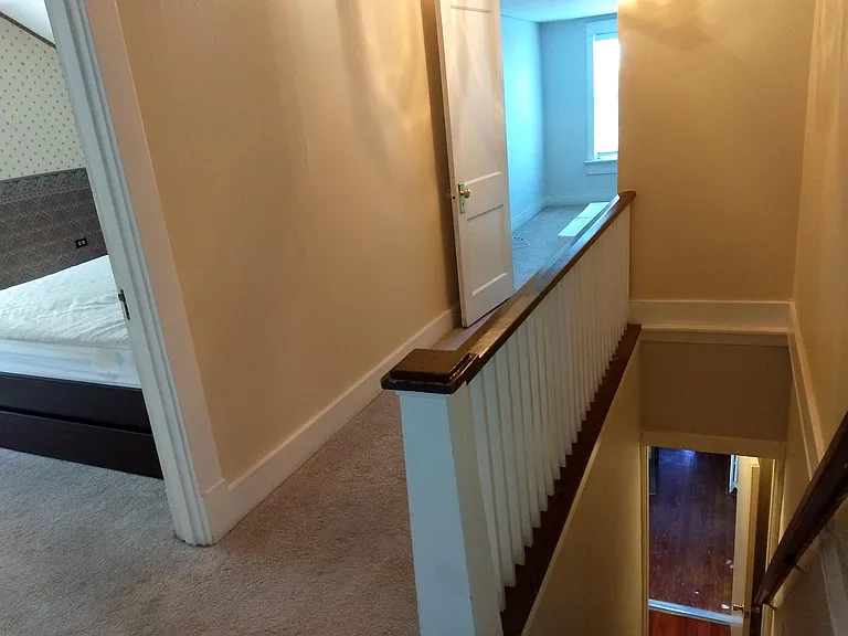 View down the stairs with bedroom #1 on left and bedroom #3 in the middle.