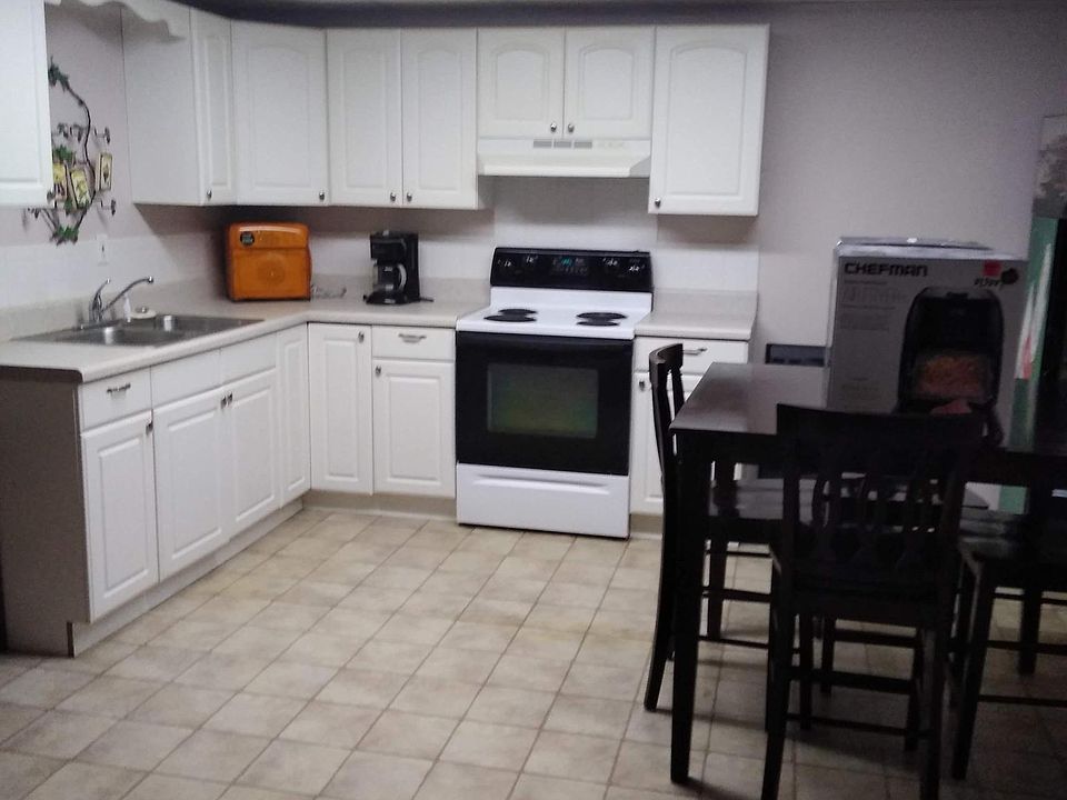 Fitted Kitchen with dining table and chairs