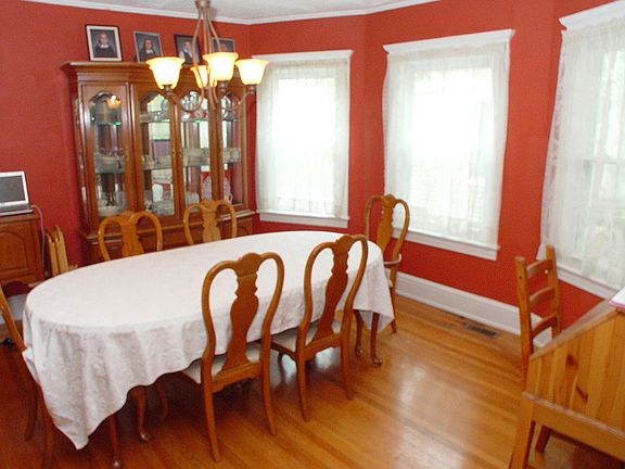 Formal dining room with triple windows.