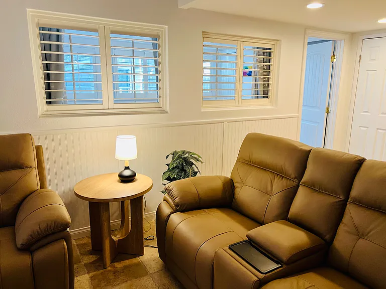 From the living room you can look through the shutters into the guest room and to the outside windows. Shutters and then the drapes can be closed off