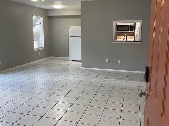 Tile floors throughout large living room and dining space.
