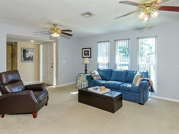 Living Room Area Features Double Ceiling Fans to Keep You Cool!