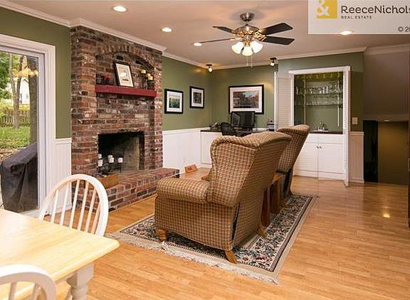 Hearth room with brick fireplace, desk and wet bar.